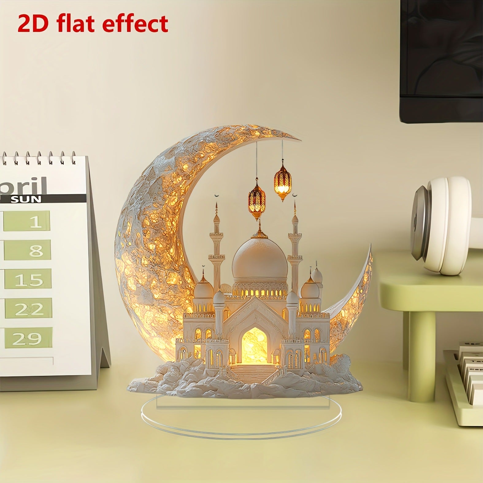 Decorative lamp shaped like a crescent moon with a miniature mosque on a desk.