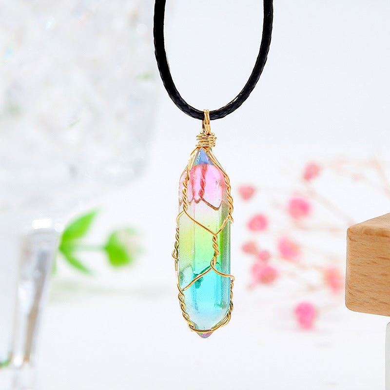 Necklace with a colorful crystal pendant on a blurred natural background