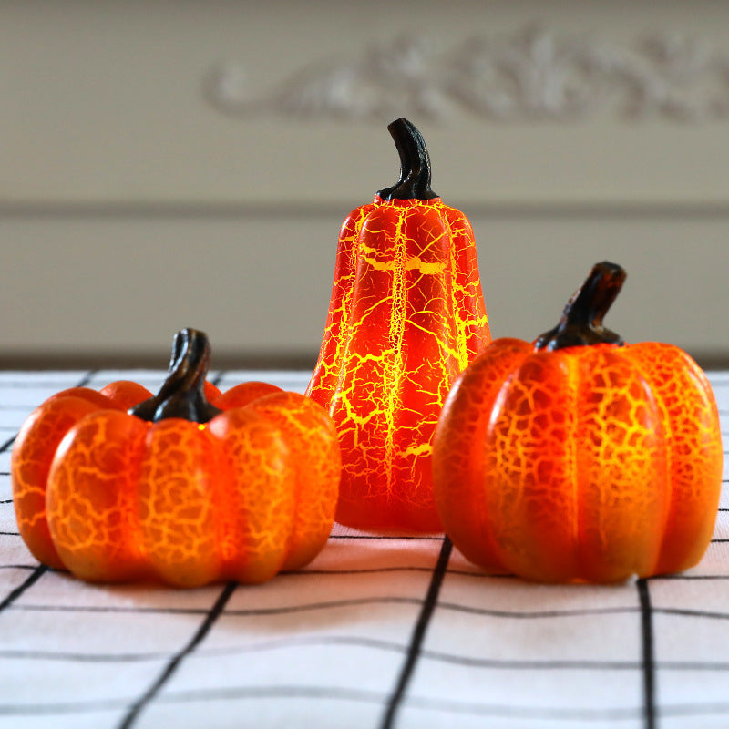 Decorative pumpkins with a cracked texture on a tablecloth.