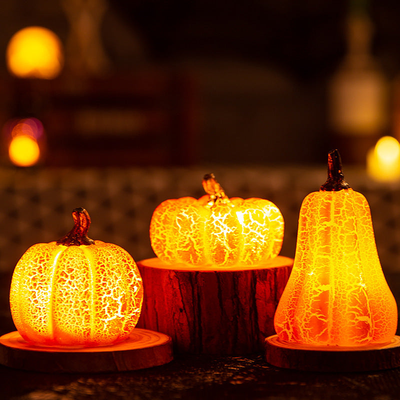 Three glowing pumpkin-shaped lights on a dark background