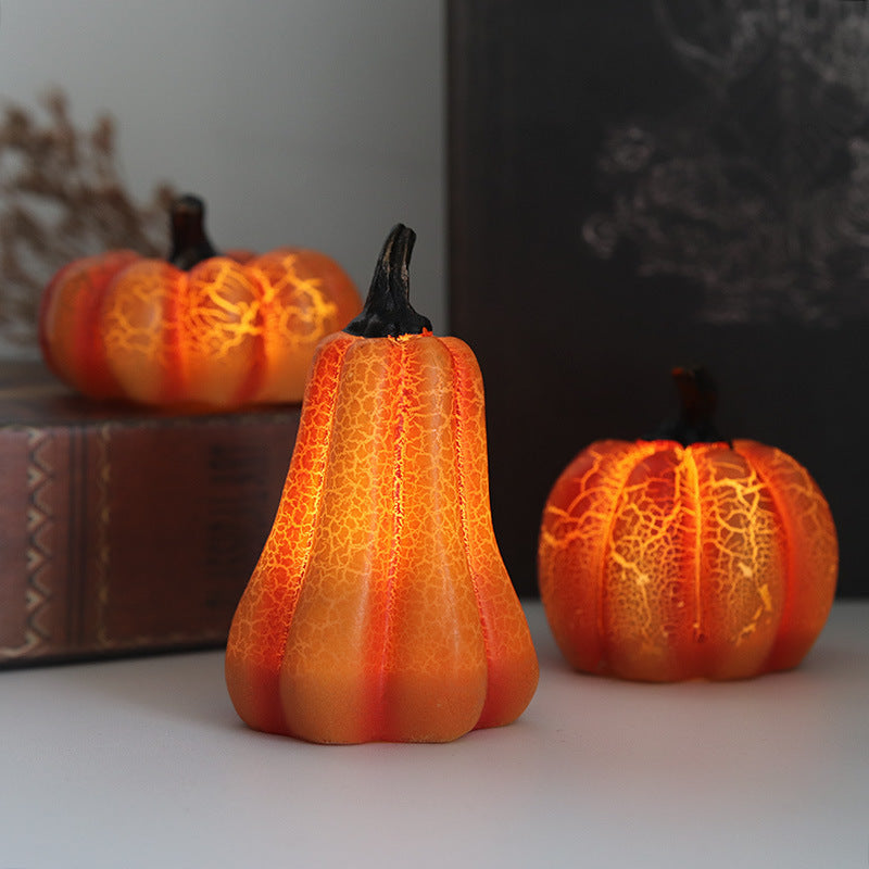 Three decorative pumpkins with textured surfaces on a neutral background