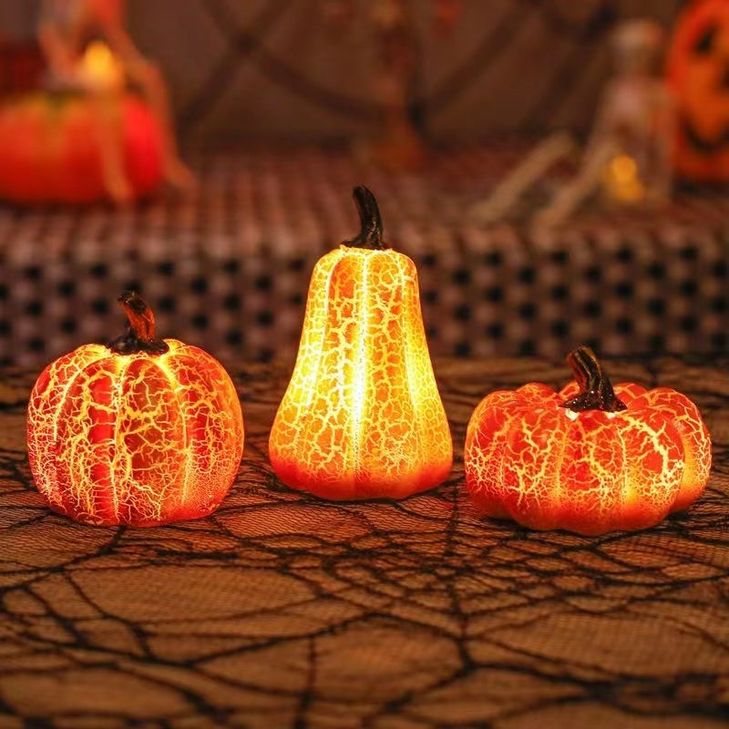 Three illuminated decorative pumpkins on a textured surface with blurred Halloween-themed background.