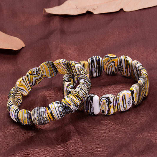 Marbled patterned bracelet on a brown fabric background