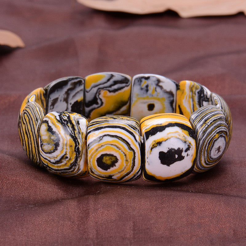 Marbled patterned bracelet on a brown fabric background