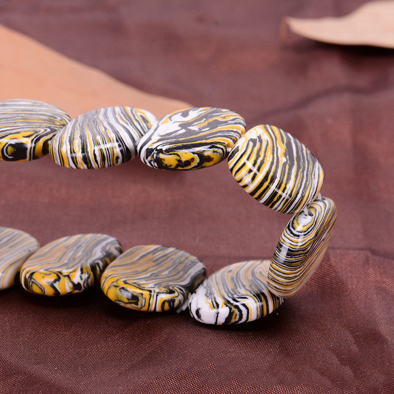 Marbled stone bracelet on a brown fabric background