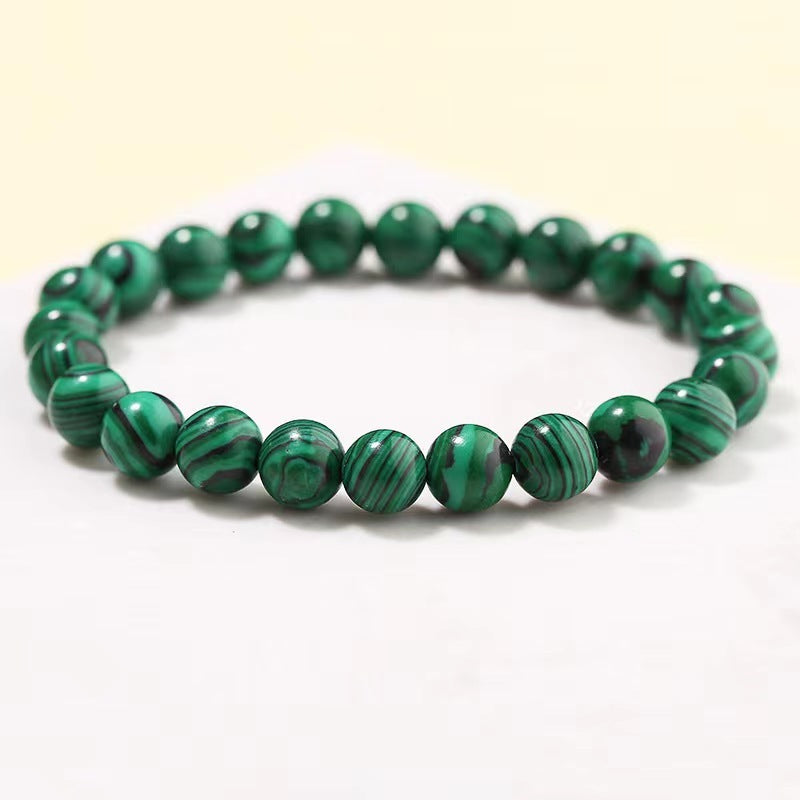Green beaded bracelet on a white background