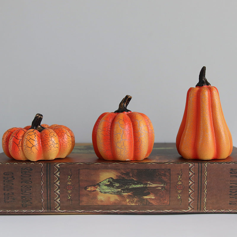 Three decorative pumpkins on an old book with a gray background