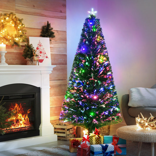Colorful Christmas tree with lights in a living room setting.