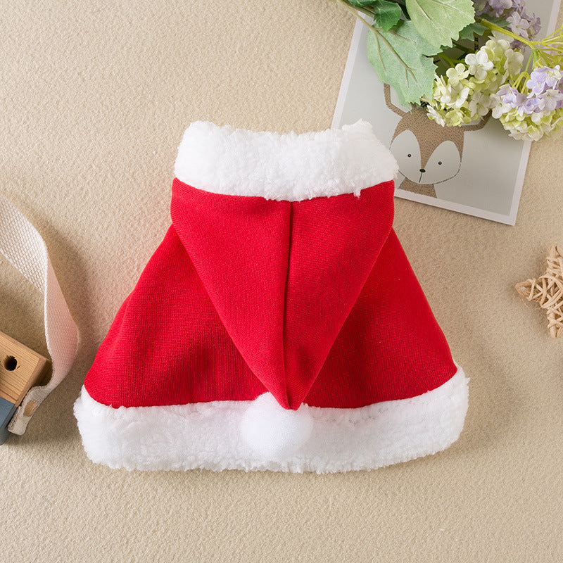 Red and white Santa hat on a beige surface with decorative elements.