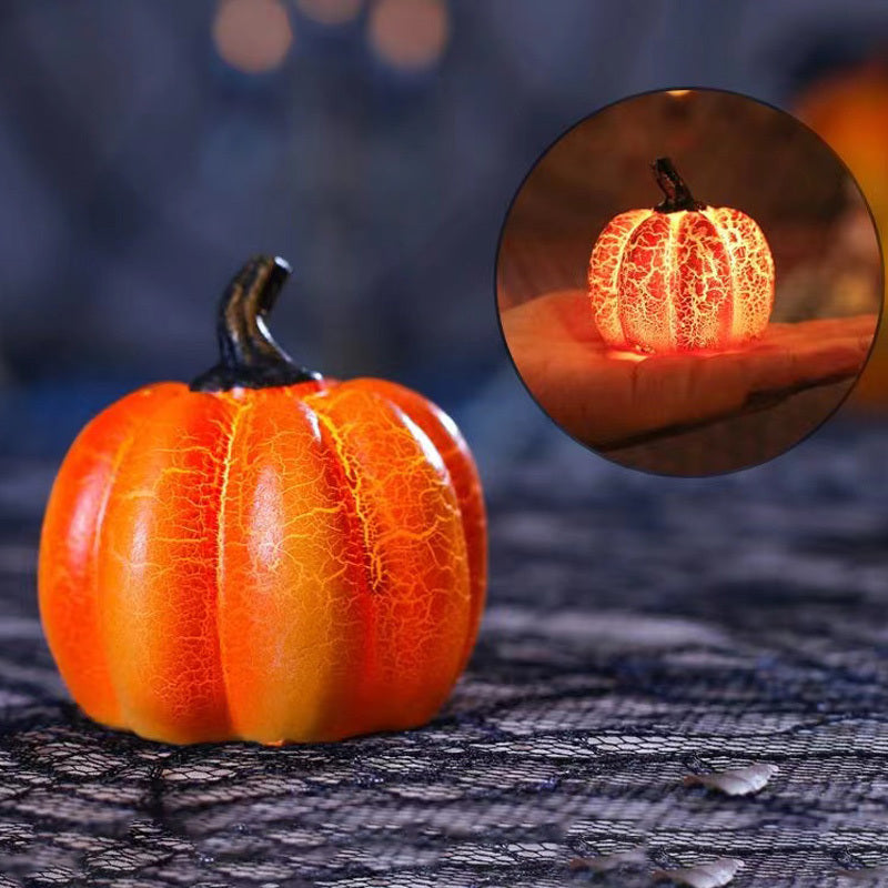Decorative pumpkin with a glowing interior on a dark textured surface